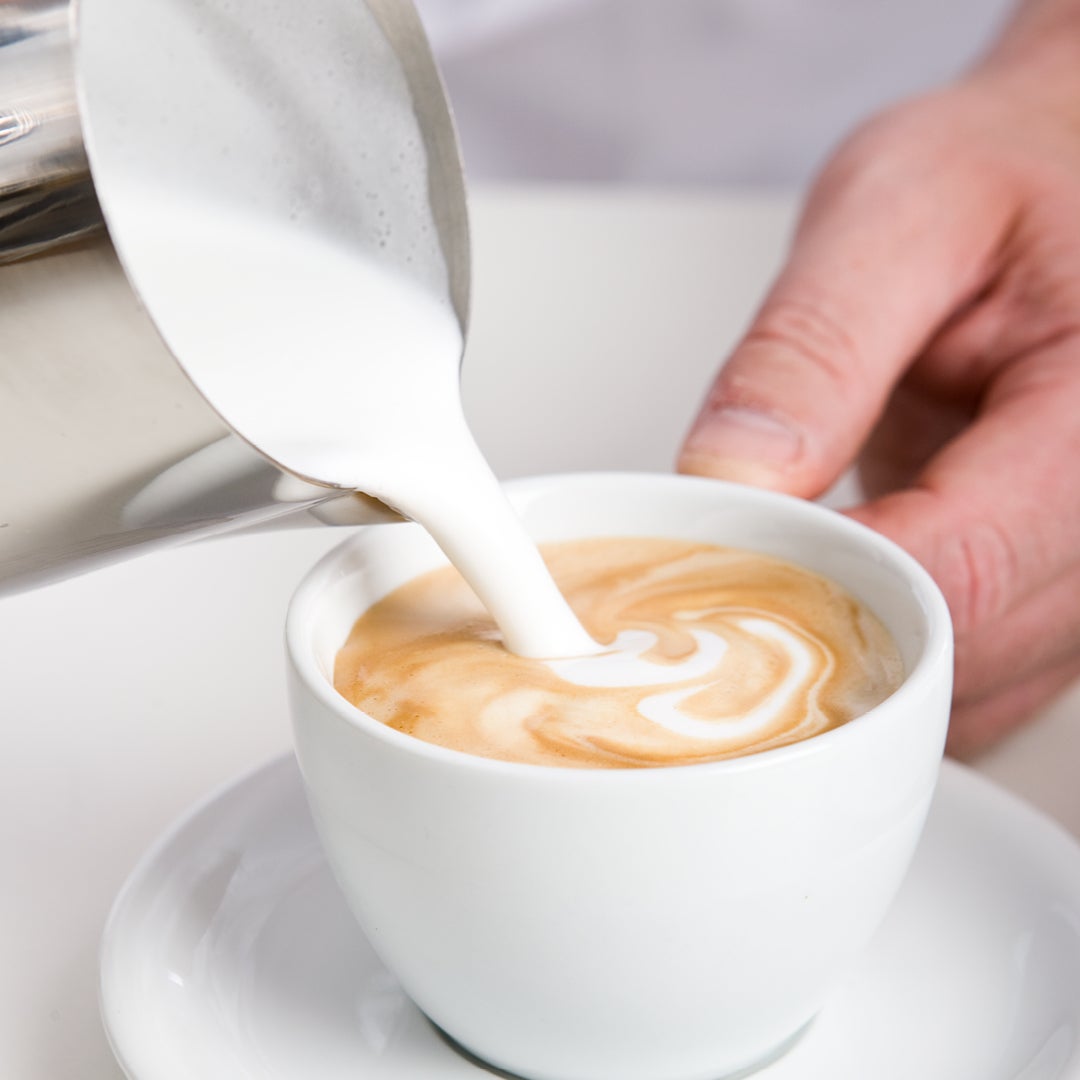 pouring milk into coffee