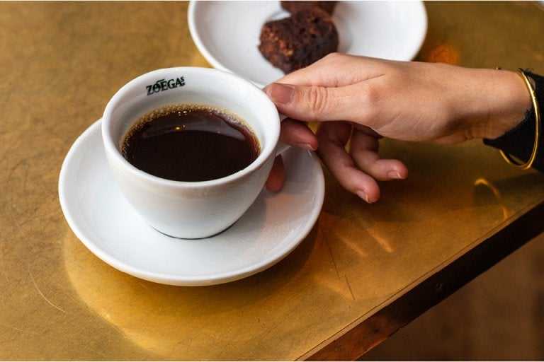 hand grabbing a coffee cup