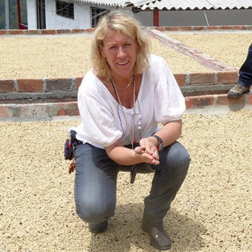 Kvinna har kaffebönor i sin hand 