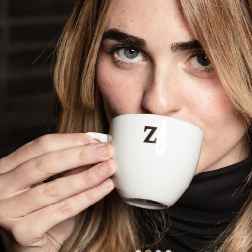 Kvinna dricker kaffe ur Zoégas kopp